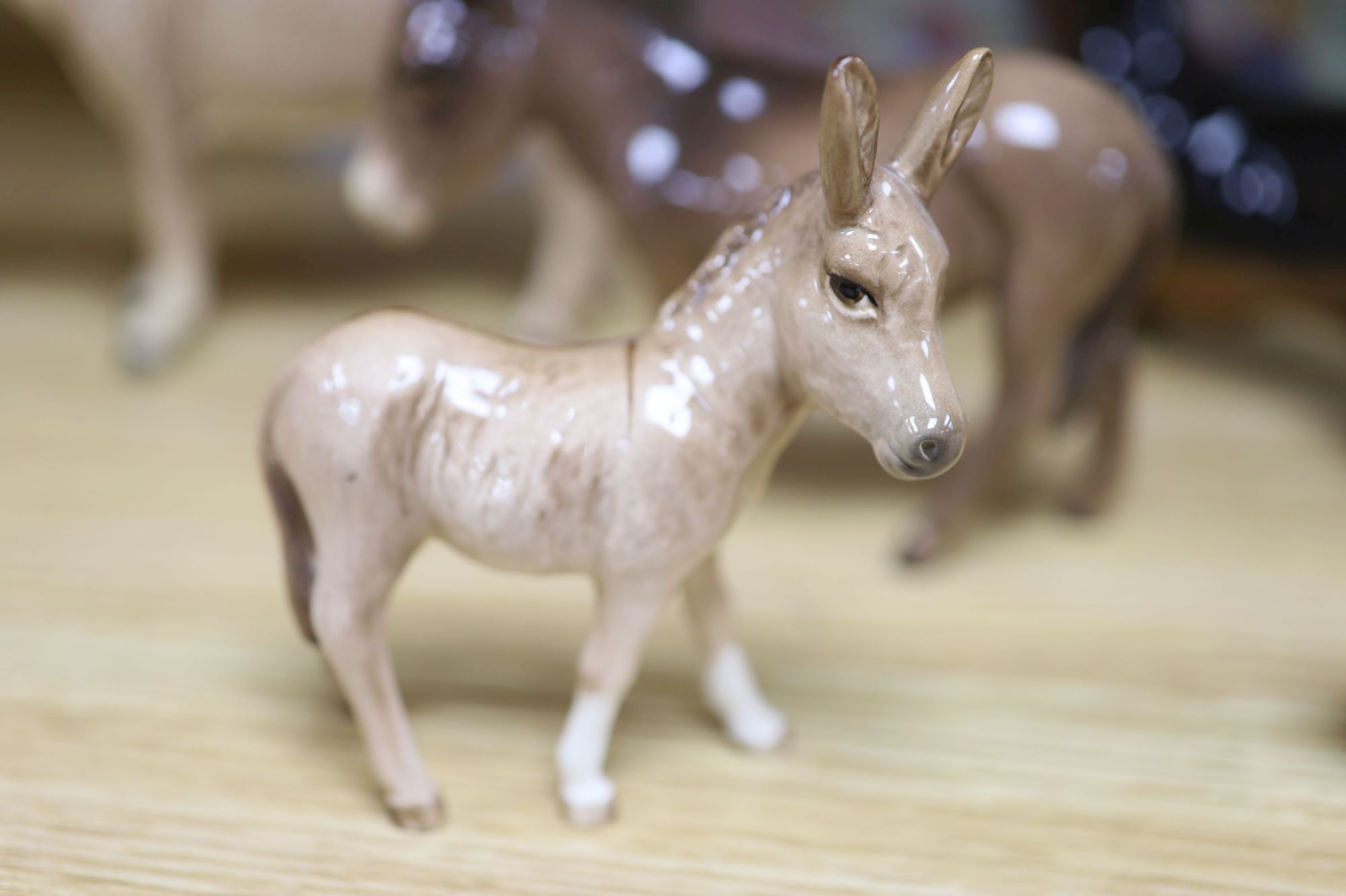 Three Beswick donkeys and four dogs, and four Tales of Honeysuckle Hill figures, tallest 13cm